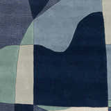 Close-up of the Crawfordsville Modern rug. Hand tufted wool rug in dark blue, denim, sage, and gray with a geometric pattern. Swatch