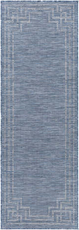 Close-up of the blue Corlette Area Rug, featuring a geometric border and woven texture. Design-Runner
