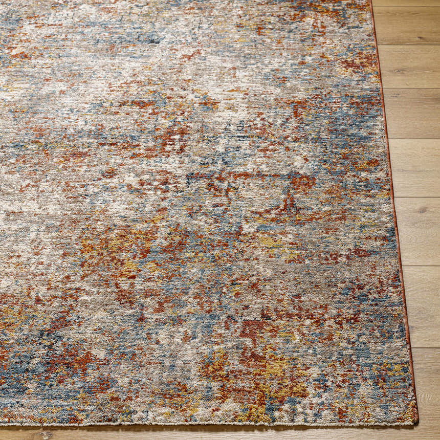 Close-up of the Cranfield Area Rug showing its brick red, cream, blue, and mustard contemporary design on wood floors. Front