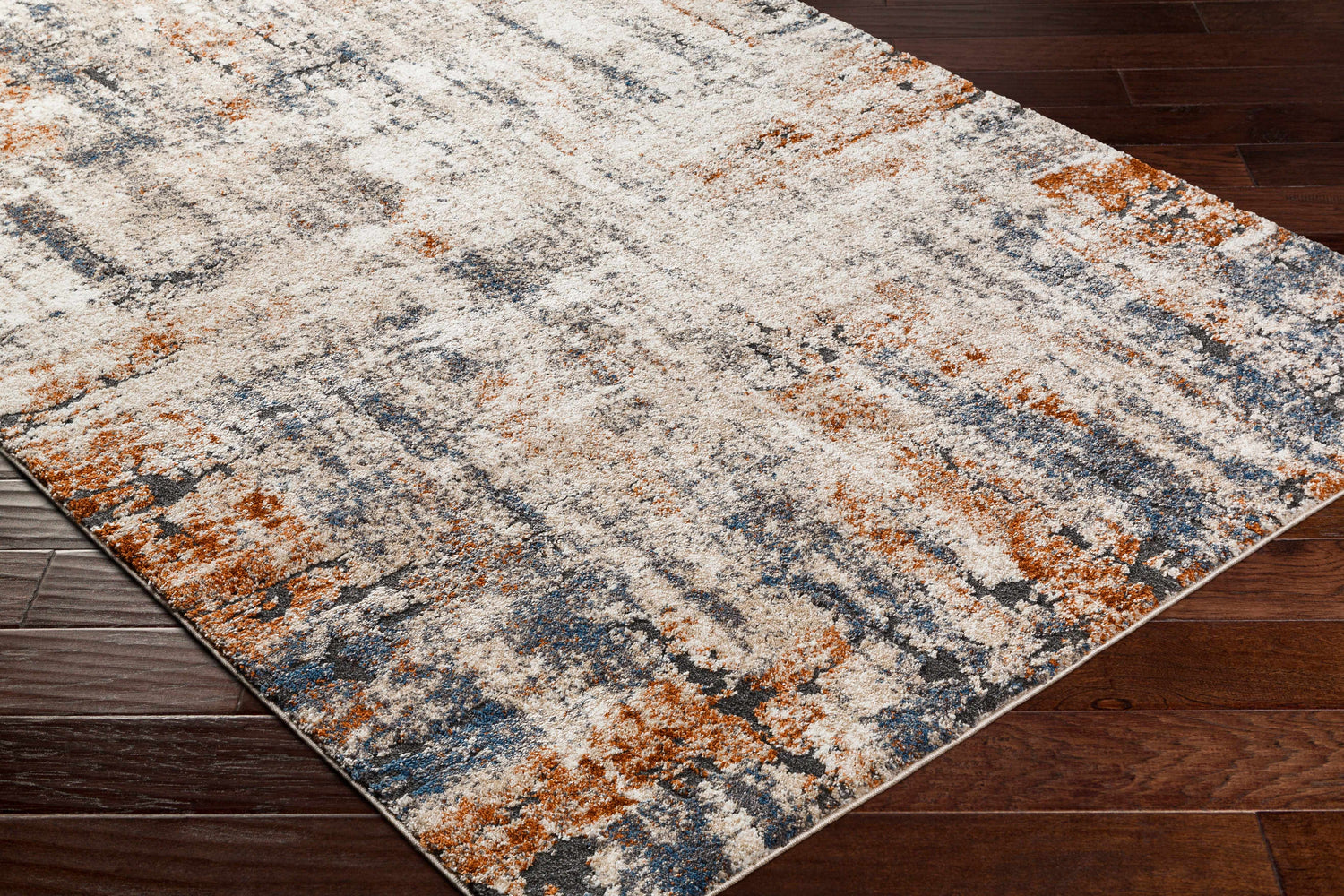 Close up of the Cashi Thick Luxe Rug showing its clay, mocha, and off white abstract design. Corner