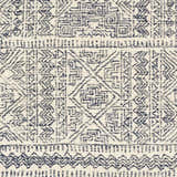 Close-up of the Cottenham Area Rug. Hand-tufted wool rug with a bohemian-inspired navy blue and ivory geometric pattern. Swatch