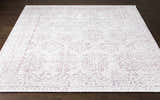 Close-up of the Cunderdin Carpet, a hand-knotted rug in mauve and white with a traditional farmhouse design. Front