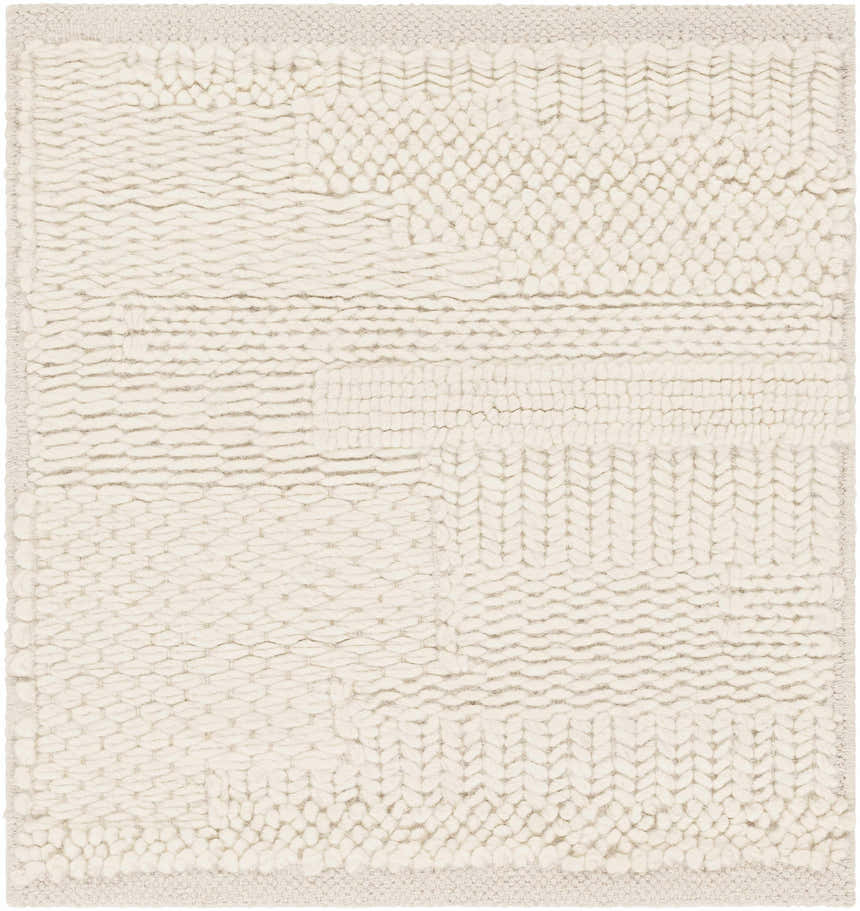 Close-up of the textured Cypress Cream Wool Rug, featuring a hand-woven design with chunky, looped wool in a soft cream color. Swatch