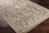 Close-up of the Dallas Area Rug - Clearance, a hand-knotted rug in charcoal, sage, and beige with a traditional oriental pattern. Corner