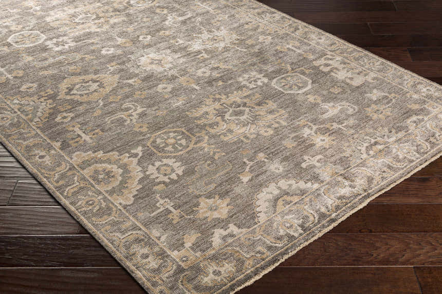 Close-up of the Dallas Area Rug - Clearance, a hand-knotted rug in charcoal, sage, and beige with a traditional oriental pattern. Corner