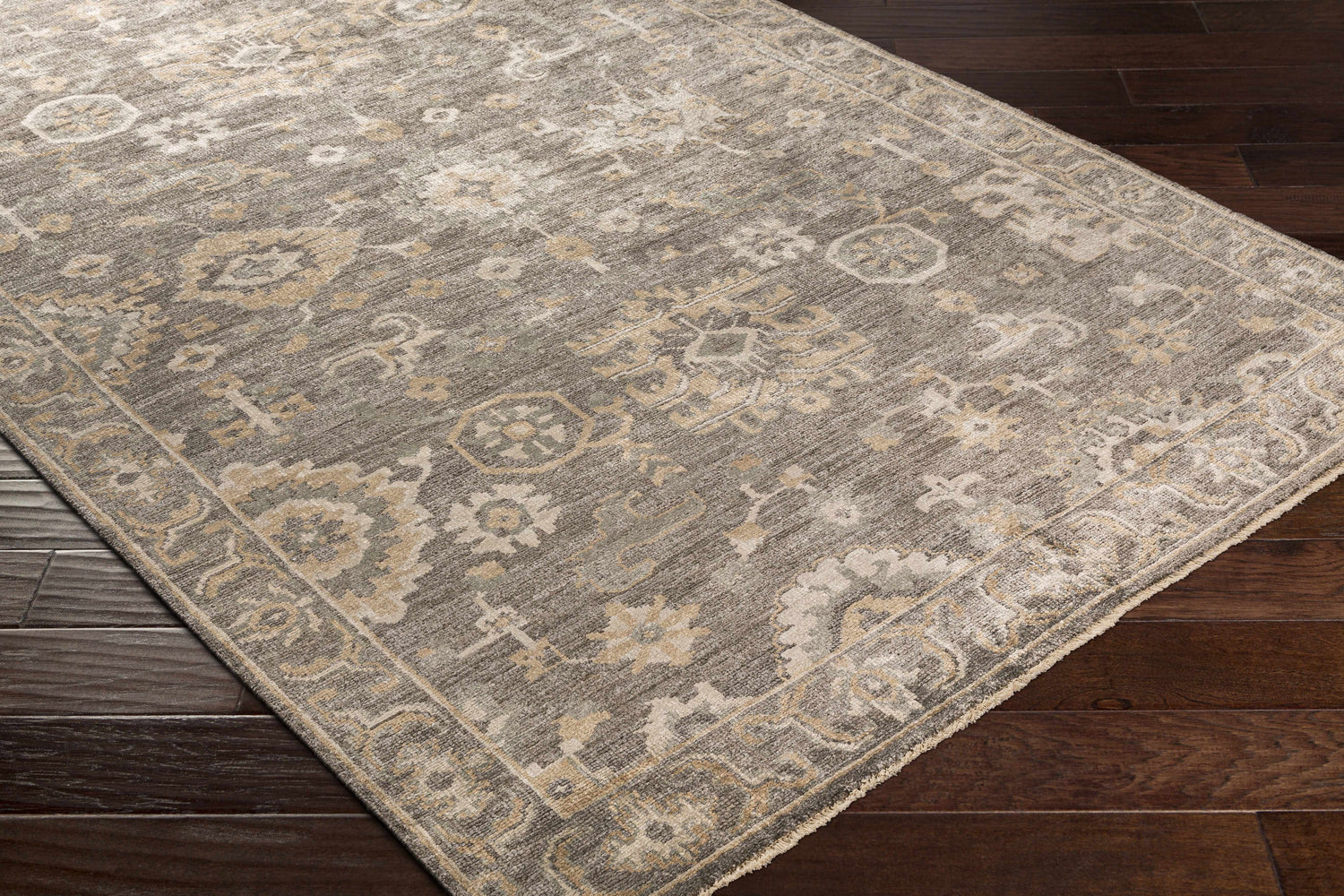 Close-up of the Dallas Area Rug - Clearance, a hand-knotted rug in charcoal, sage, and beige with a traditional oriental pattern. Corner