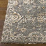 Close-up of the Dallas Area Rug. Charcoal, dusty sage, and beige tones create a traditional, hand-knotted pattern. Front