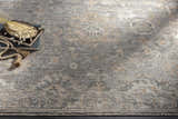 Close-up of the hand-knotted Dallas Area Rug. Features charcoal, dusty sage, and tan colors in a traditional pattern. Styleshot