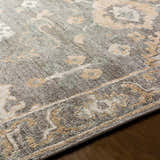 Close-up of the hand-knotted Dallas Area Rug. Features charcoal, dusty sage, gray, and tan colors with a traditional pattern. Texture
