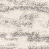 Close-up of the Dagami Area Rug. Shag rug with a horizontal striped pattern in gray, light gray, and white. Swatch