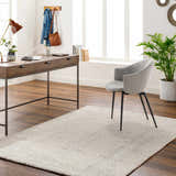 Home office with wood desk, gray chair, and beige Daiva Luxe Rug. Roomscene-Rectangle