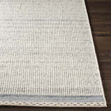 Close up of the Dalaoig rug, a flat woven wool rug in cream and charcoal on a dark wood floor. Front