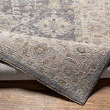 Close-up of the Dalupirip rug showing its traditional pattern, brown, denim, and gray colors, and thick, luxe texture. Fold