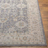 Close up of the Dalupirip rug showing its gray, beige, and brown vintage pattern and texture. Front