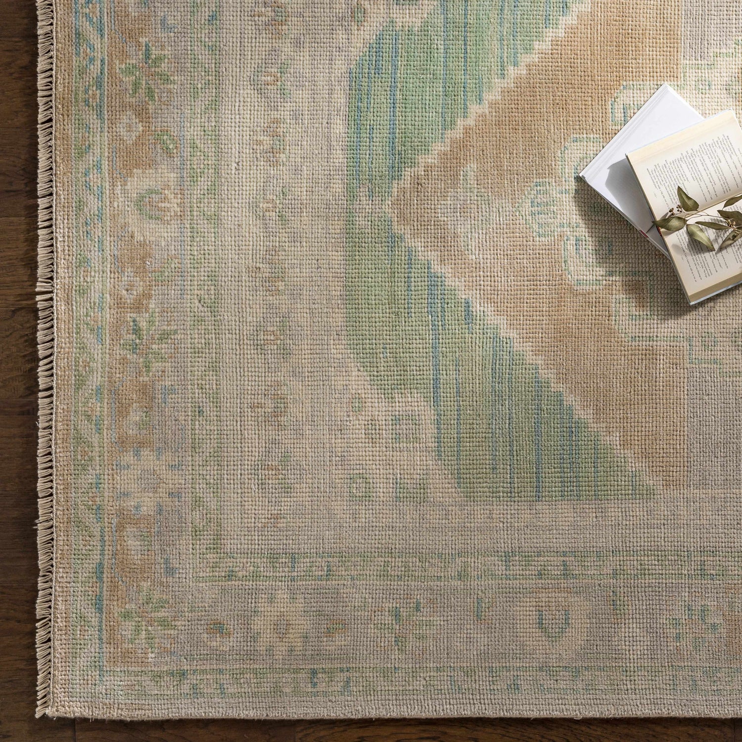 Close-up of a hand-knotted Danao Premium Rug. Cream, light sage, ice blue, and dusty pink oriental rug pattern detail. Styleshot