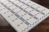 Close-up of Dapitan Indoor & Outdoor Rug. Dark gray and white rug with a contemporary geometric pattern. Corner