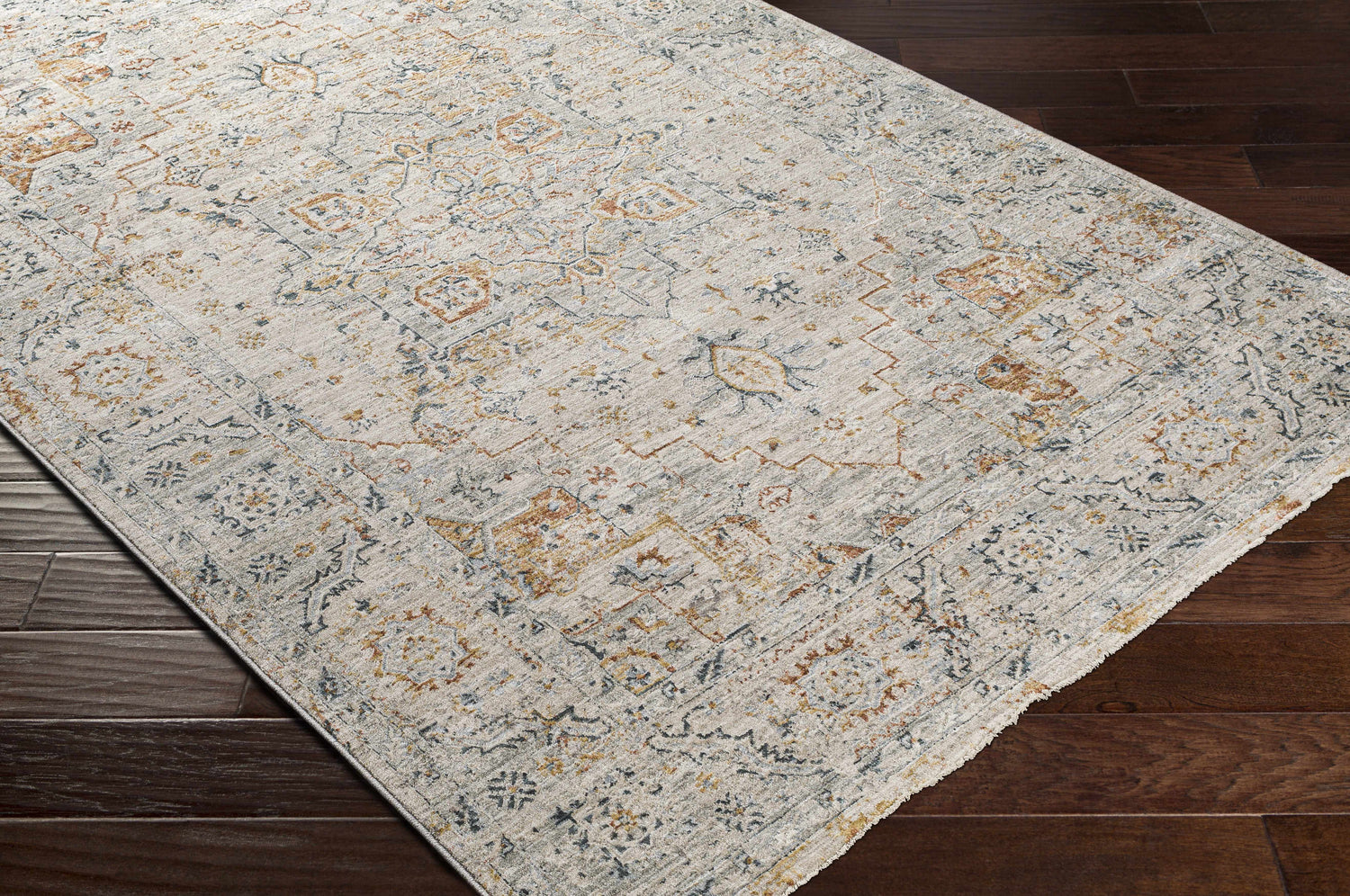 Close-up of the Darvel Luxe Rug showing its brick red, cream, and gray Persian-inspired pattern and soft texture. Corner