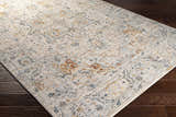 Close-up of the Darvel Luxe Rug. Cream rug with brick red, dusty sage, gray, and mustard traditional Persian-style pattern. Corner