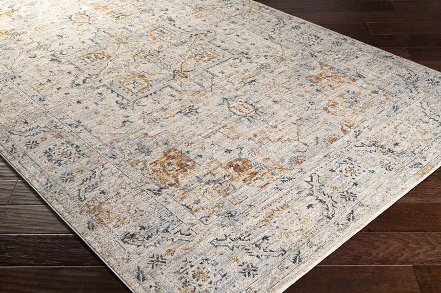 Close-up of the Darvel Luxe Rug. Cream rug with brick red, dusty sage, gray, and mustard traditional Persian-style pattern. Corner