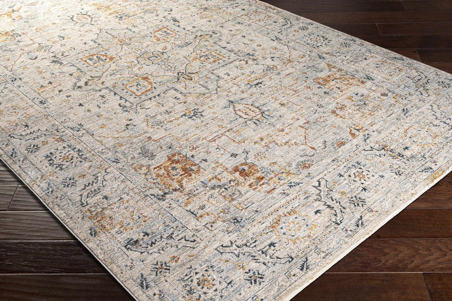 Close-up of the Darvel Luxe Rug. Cream rug with brick red, dusty sage, gray, and mustard traditional Persian-style pattern. Corner
