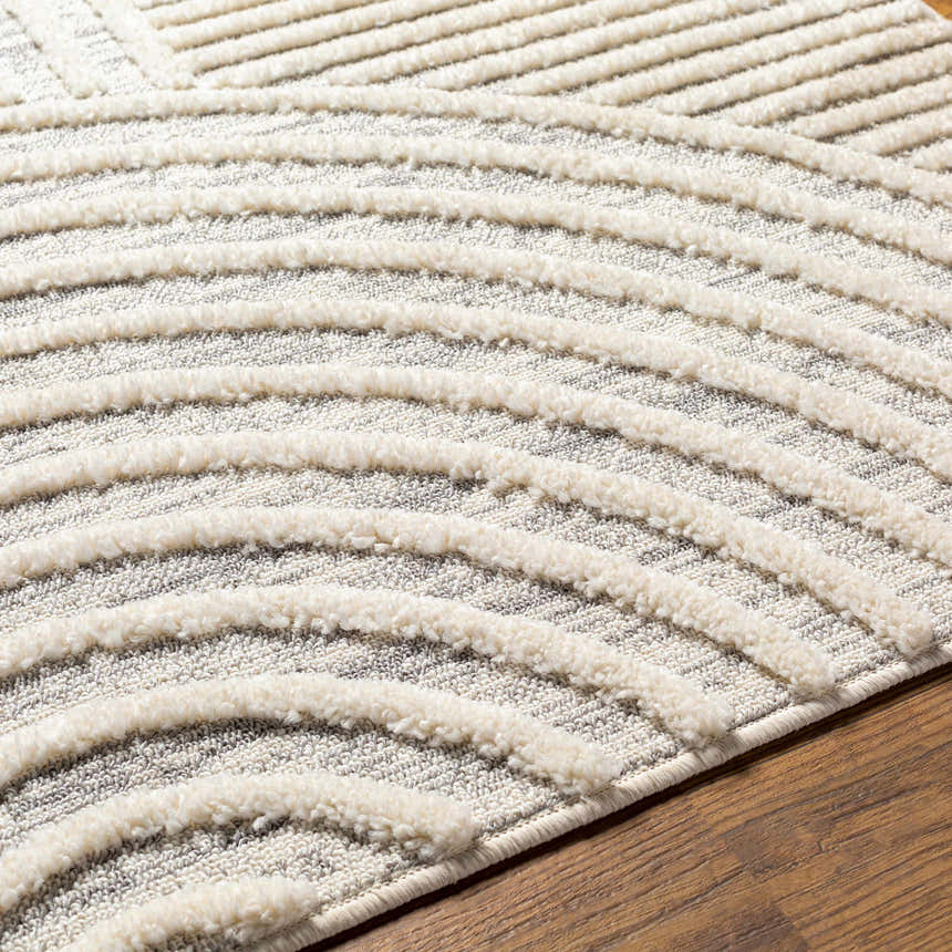 Close up of the Dauin 3D Rainbow Area Rug. Cream textured lines on a gray geometric pattern. Contemporary style. Texture