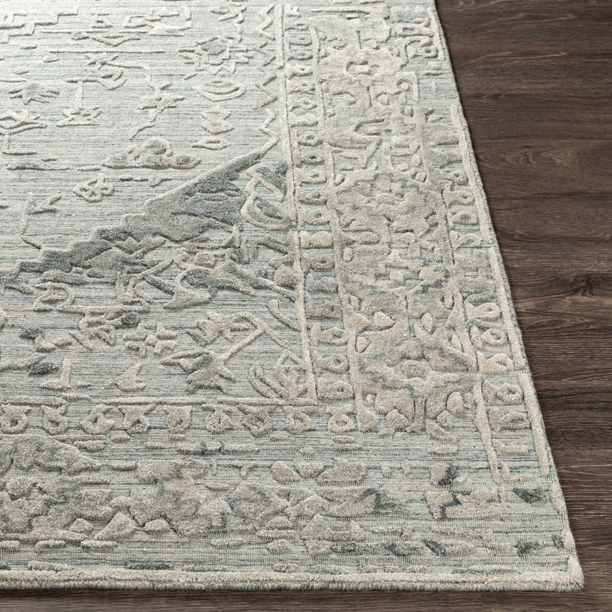 Close up of the Davilla Area Rug, showing the light gray, sage, and seafoam Persian-style pattern. Front
