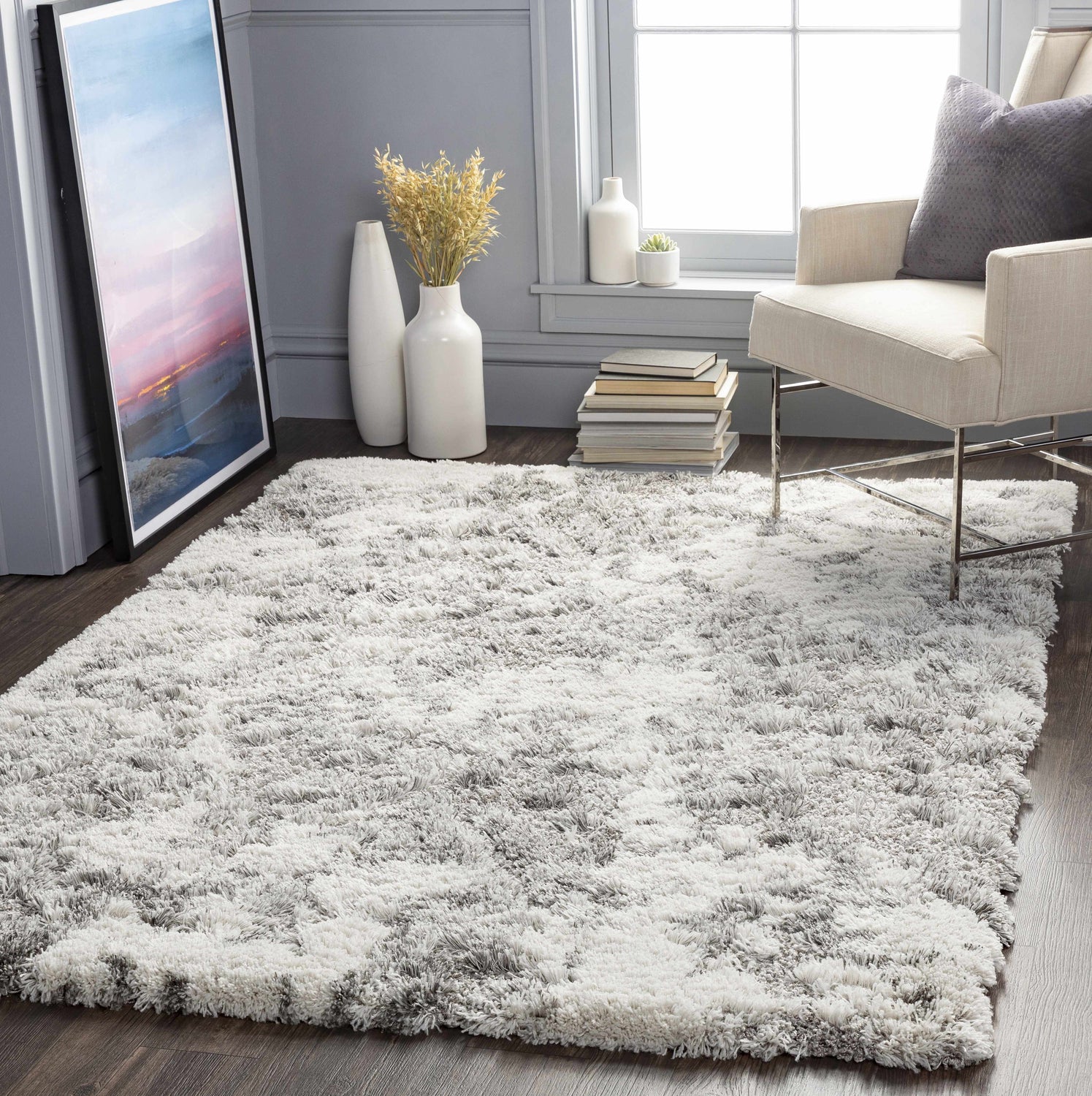 Cozy gray room scene with Dawesville Gray White Shag Area Rug, chair, artwork, and vases by a window. Roomscene-Rectangle