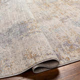 Close-up of the Deka Deep Teal Thick Luxe Rug showing its brown, gray, and teal contemporary pattern and plush texture. Fold