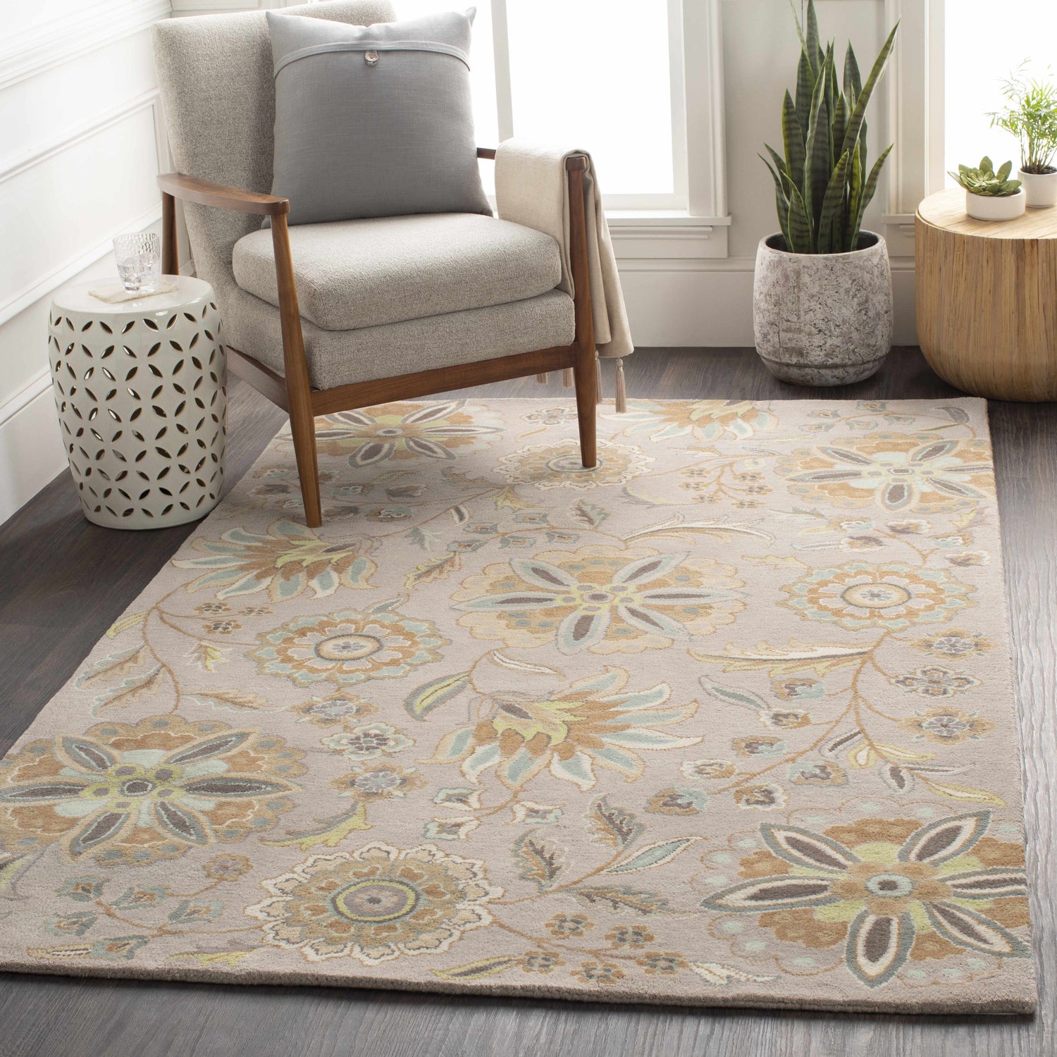 Living room scene with a floral Denio Area Rug in brown, sage, and blue tones under a chair and side tables. Roomscene-Rectangle