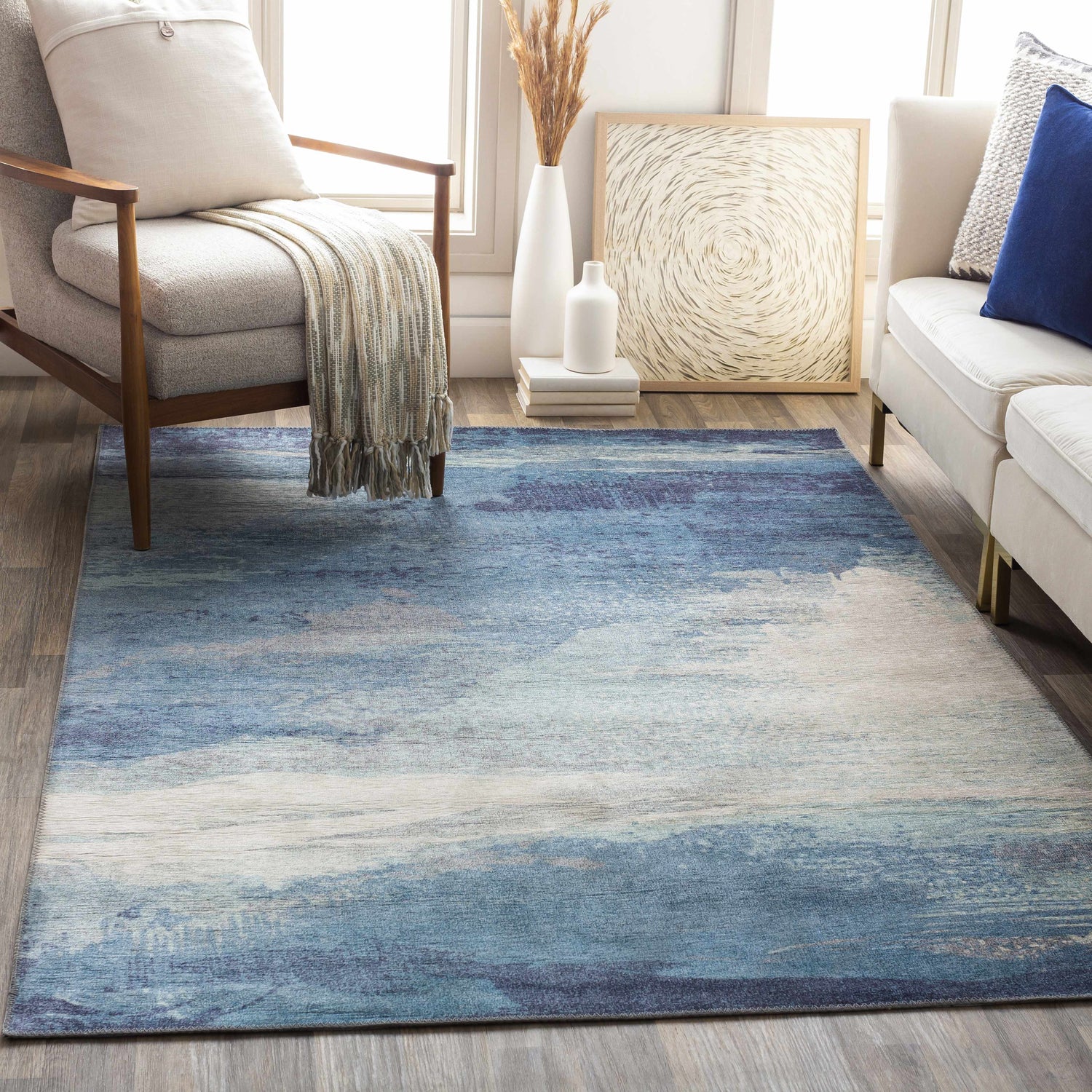 Living room scene with blue, cream, and charcoal Deport Area Rug. Coastal Grandmother style. Roomscene-Rectangle