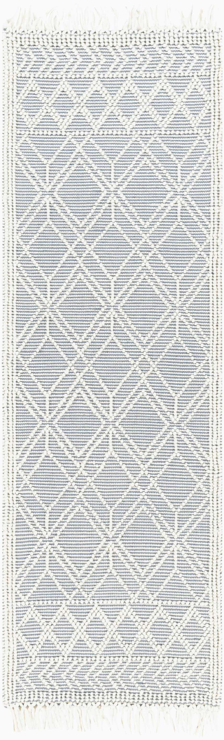 Close-up of Ramsbury Denim Blue Wool Rug. Geometric diamond pattern in denim blue and ivory with fringed edges. Hand woven texture. Design-Runner-268
