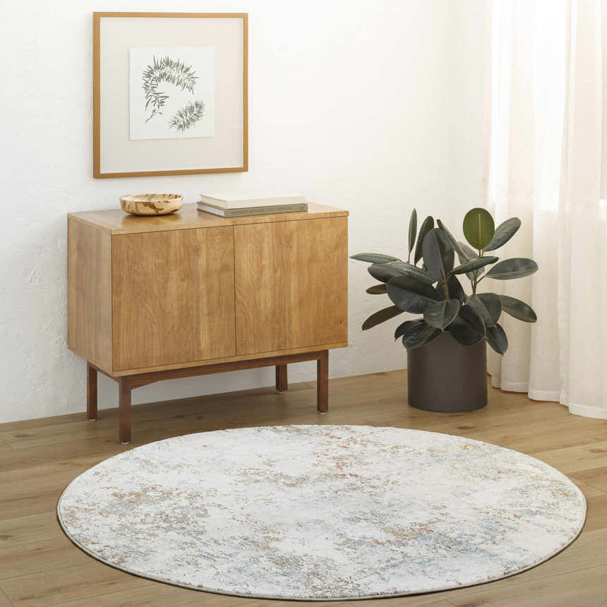 Living room scene with a round Dinos Thick Luxe Rug, wood cabinet, plant, and neutral decor. Roomscene-Round