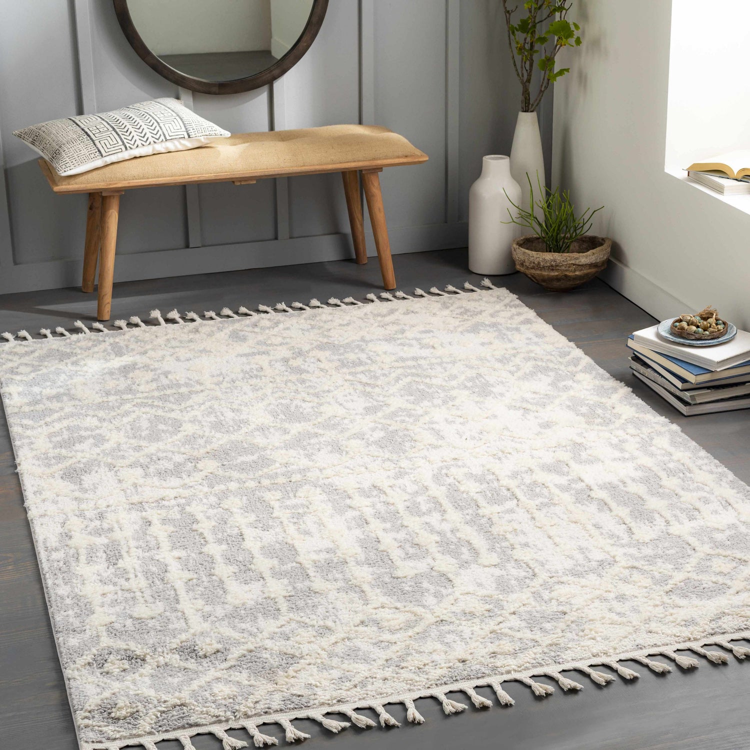 Entryway with cream and gray Dolo Area Rug, wood bench, round mirror, and neutral decor. Roomscene-Rectangle