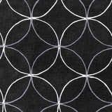 Close-up of the Delano Area Rug. Black rug with a geometric pattern of intersecting white and charcoal gray circles. Swatch