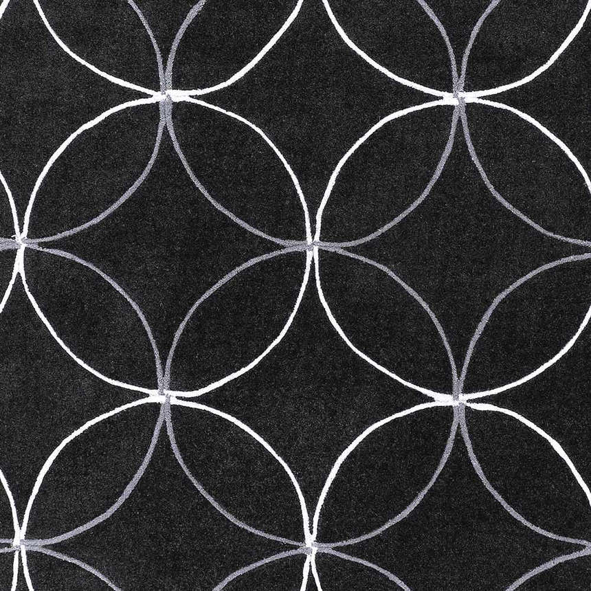 Close-up of the Delano Area Rug. Black rug with a geometric pattern of intersecting white and charcoal gray circles. Swatch