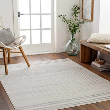 Entryway with a Dung Area Rug in cloud gray, light gray, and smoke, styled with a white chair and wooden bench. Roomscene-Rectangle