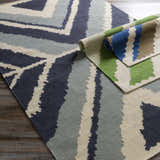 Close-up of the Doncaster Area Rug. Hand woven wool rug in charcoal, dark blue, and light beige with a contemporary pattern. Roomscene-Rectangle