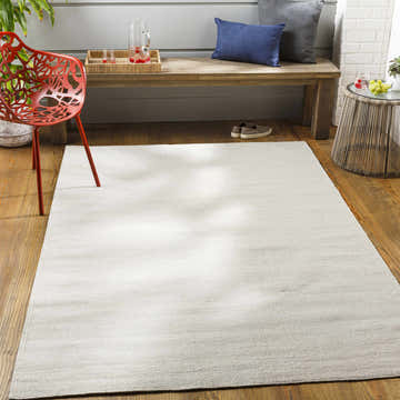 Patio scene with cream Dormansland Indoor Outdoor Rug, wood bench with pillows, and red accent chair on wood floor. Roomscene-Rectangle