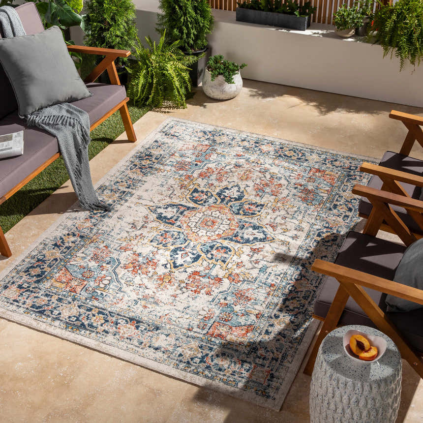 Outdoor patio scene with the Dorval Traditional Rug, gray chairs, and potted plants. Roomscene-Rectangle