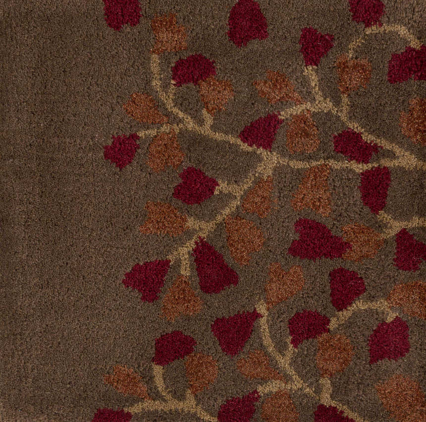 Close-up of the Dovercourt Clearance Rug showing the wool texture and brick red, dark red, and mustard leaf pattern. Swatch
