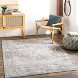 Living room scene with a Dowell Luxe Textured Area Rug in gray, brown, and mustard tones. Rattan chair and cabinet add a mid-century modern vibe. Roomscene-Rectangle