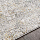 Close up of the textured Dowell Luxe Area Rug, in light gray, off white, and mustard on a wood floor. Texture