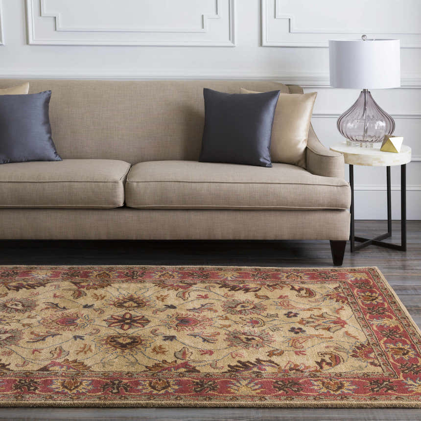 Living room scene with a Cherryfield Hand Tufted Brown & Rust Wool Rug. Beige sofa with gray pillows, marble side table, lamp. Roomscene-Rectangle