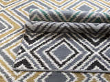 Close-up of the hand woven Druid Area Rug. Charcoal, ivory, and mustard geometric diamond pattern. 100% wool texture. Styleshot