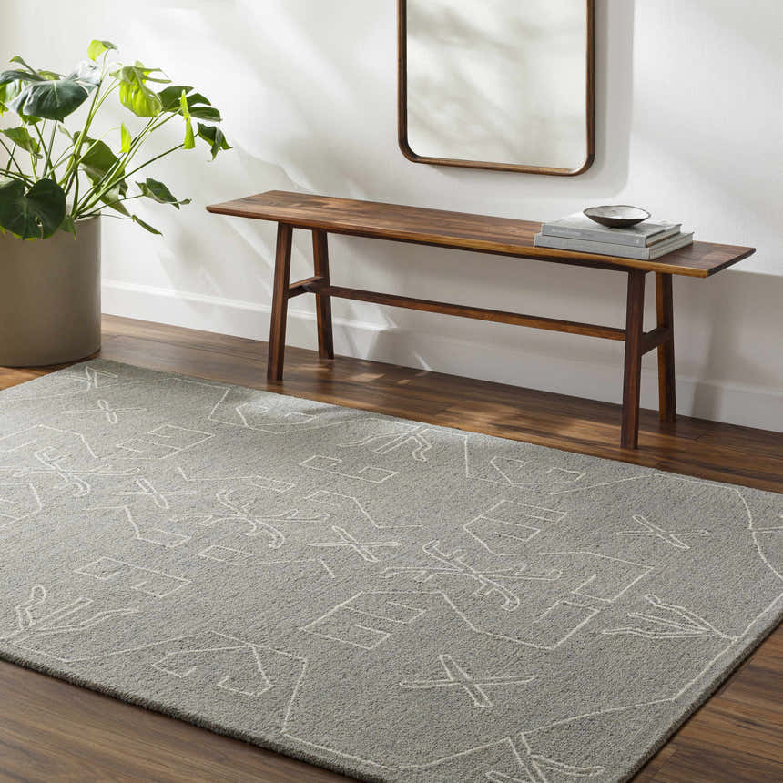 Entryway with gray Duard Modern Wool Rug, wood bench, mirror, and potted plant. Roomscene-Rectangle
