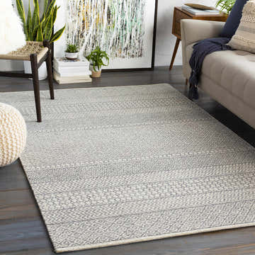 Living room with a beige sofa and the Dugway Tufted Maroc Wool Rug in light beige and charcoal. Roomscene-Rectangle