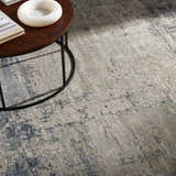 Close-up of the Devonport Thick Luxe Area Rug showing its light gray, taupe, and navy contemporary pattern and soft texture. Styleshot