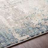 Close up of the Devonport Thick Luxe Area Rug showing its light gray, taupe, and pale blue contemporary design. Texture