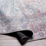 Close-up of the Baltinglass Gray Washable Rug showing its traditional, oriental pattern and chenille-polyester texture. Fold