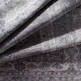 Close-up of the Baltinglass Gray Washable Rug showing its traditional oriental pattern, brown, gray, and cream colors. Fold